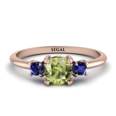 a ring with three stones and the word segel on it's center stone