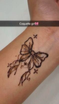 a woman's arm with a tattoo on it that is decorated with flowers and butterflies