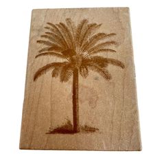 a wooden coaster with a palm tree on it