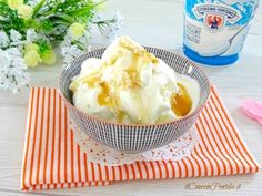 a bowl filled with ice cream sitting on top of an orange and white place mat