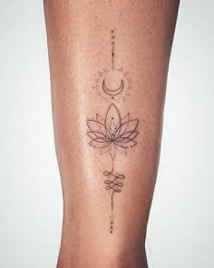 a woman's leg with a tattoo on it that has a flower and crescent