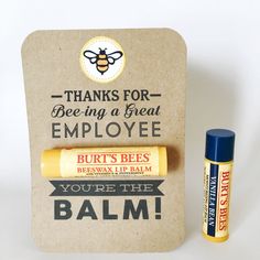 an empty box with two bees on it next to a tube of balm