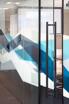 an office with glass walls and blue geometric designs