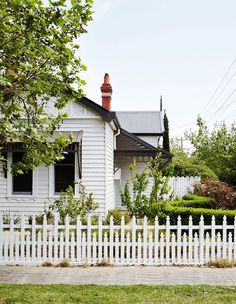 a white picket fence in front of a house