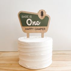 a cake with a sign that says sage is one happy camper on the top