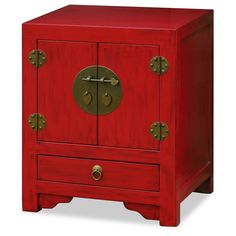 a red wooden cabinet with two brass knobs