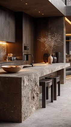 a modern kitchen with granite counter tops and dark wood cabinets, along with stools