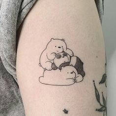 a woman with a tattoo on her arm holding two teddy bears in the shape of a heart