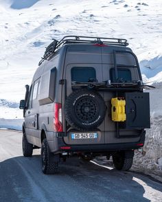 an suv parked on the side of a snowy road