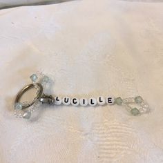 a keychain with the word cuddle spelled in white letters on top of it