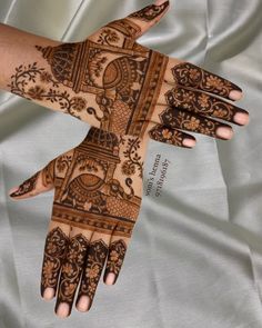 two hands with henna designs on them