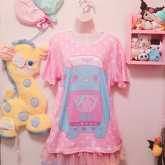 "Is a nurse bear taking care of her patient. The word in japanese means \"PAIN\" This new all over print t-shirt features a relaxed fit for Cuties. Made of 100% mesh cloth, this t-shirt is durable, breathable and soft. * 7.05 Oz. 100% polyester. * Double-needle hemmed sleeves and bottom. * Machine wash cold. The print on garment body is unable to fade. Color may appear different in the photo. Thank you'ω ♥ ☆ ★ ♪ Model by: katiebabydoll" Casual Graphic Print T-shirt For Pajama Party, Casual Pink T-shirt For Pajama Party, Playful Short Sleeve T-shirt With All Over Print, Casual Cartoon Print Sleep Top, Casual Sleep Tops With Cartoon Print, Summer Cartoon Print Sleep Tops, Summer Sleep Tops With Cartoon Print, Pink Kawaii Sleepwear With Cartoon Print, Casual Cartoon Print Tops For Pajama Party