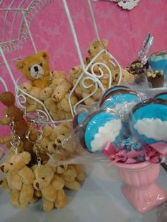 teddy bears and other items are sitting on a table with pink wallpaper in the background