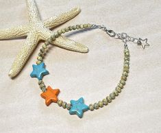 Cute and colorful beachy boho summer anklet!  This was created using "yellow" Japanese Picasso seed beads, tiny turquoise seed beads, and Howlite gemstone star beads in turquoise blue and orange.  Anklet closes with a lobster clasp, and is adjustable with a 1" extender chain. Anklet measures 9-1/4" to 10-1/4" with the extender chain. Thank you for shopping with The Lucie Collection! Bohemian Beaded Friendship Bracelets For Beach Season, Bohemian Beaded Bracelet With Starfish For Beach Season, Bohemian Starfish Beaded Bracelet For Beach Season, Bohemian Beaded Bracelet With Starfish Charm For Vacation, Bohemian Anklets With Round Beads For Beach Season, Bohemian Beaded Strand Bracelet With Starfish Charm, Bohemian Beaded Bracelet With Starfish Charm, Bohemian Strand Beaded Bracelet With Starfish Charm, Summer Beach Beaded Bracelets With Spacer Beads