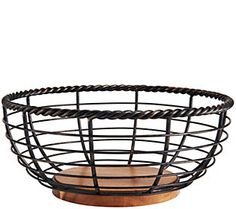 a black wire basket with wooden cutting board in the center on a white background photo