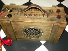 a wooden box with some tools in it on a checkerboard pattern flooring