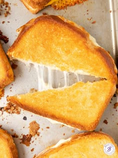 toasted sandwiches sitting on top of a pan