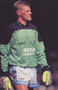 a soccer player in green and white uniform