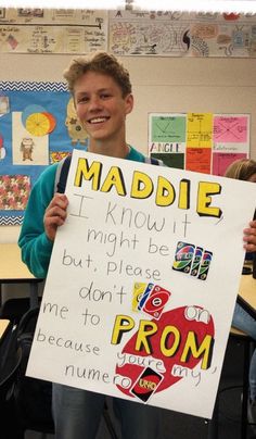 a young boy holding up a sign in front of him