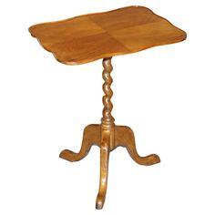 a wooden table with a carved top on a white background in the shape of an elephant's head