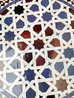 an intricately designed tile with blue, red and white tiles on the bottom half