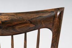 a close up of a wooden chair on a white background with wood grained back and seat