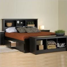 a bedroom with a bed, night stand and storage drawers on the bottom shelf in black