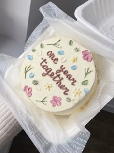 a decorated cake sitting in a plastic container