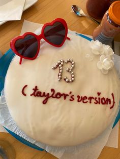 a birthday cake with sunglasses and the words taylor's version written on it is sitting on a table