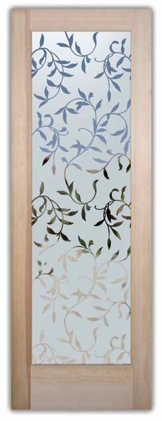 a glass door with an artistic design on the front and side panels, in light wood frame