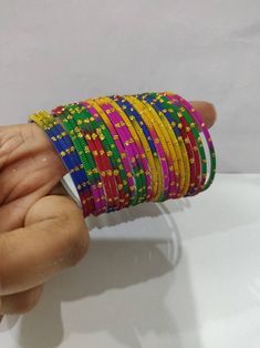 Welcome to our shop We bring to you very ethnic products from core of India almost every thing is handmade or custom made Set of 22 Bangles in multiple colors Size 2.4 We will be happy to serve you Pink Handmade Traditional Bangle, Multicolor Bangle With Colorful Beads For Festival, Multicolor Beaded Bangle For Festival, Traditional Multicolor Beaded Bracelets For Festive Occasions, Traditional Adjustable Multicolor Bangle, Festive Multicolor Traditional Beaded Bracelets, Handmade Multicolor Bracelets For Festive Occasions, Adjustable Multicolor Bangle With Round Beads, Multicolor Stackable Jewelry For Festival