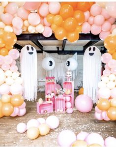 a party with balloons and decorations in the shape of ghostes, pinks and browns