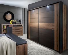 a bedroom with a bed, dresser and mirror