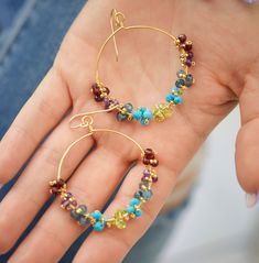 Multi-Color Gemstone Crystal Hoops Earrings - Sterling Silver or 14k Gold Filled A great way to add a pop of color to your wardrobe! These hoops are wrapped with natural gemstones and tiny gold or silver glass beads, and average 1.5 inches wide. The metal comes in your choice of sterling silver or 14k gold filled. The stones included are: - Red: Garnet - Purple: Amethyst - Blue: Blue Topaz (coated) - Turquoise EARRING LENGTH: average 2.5 inches EARRING WIDTH: average 1.5 inches EXTRAS - Each ear Multicolor Hoop Jewelry With Natural Stones, Multicolor Hoop Earrings With Natural Stones, Multicolor Multi-stone Hoop Earrings As Gift, Gold Multi-stone Hoop Earrings As A Gift, Multicolor Natural Stones Hoop Jewelry, Multicolor Multi-stone Hoop Jewelry, Multicolor Natural Stone Hoop Jewelry, Multicolor Hoop Earrings With Natural Stones For Gift, Multicolor Natural Stones Hoop Earrings As Gift