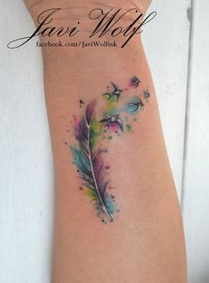 a woman's arm with a feather tattoo on it