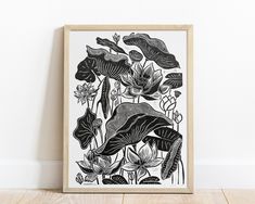 a black and white drawing of flowers on a wall next to a wood floor with a wooden frame