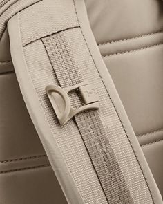 a close up view of the zippers on a jacket with a heart shaped buckle