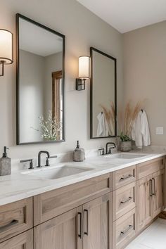 a bathroom with two sinks and mirrors in it