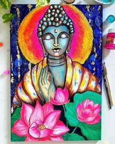 a painting of buddha surrounded by flowers and paintbrushes on a white table with watercolor paints