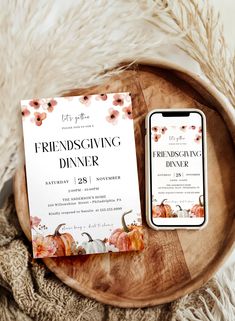 the wedding dinner is set on a wooden platter next to a phone and card