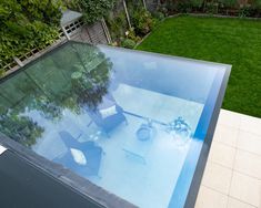 an aerial view of a backyard with a swimming pool