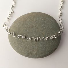 This necklace is made from sterling silver. It has a lobster claw clasp. Each spiral link is individually created for a pleasing organic feeling. The spiral links are connected with soldered silver jump rings. Please select the length you would prefer. I can make other lengths as custom orders. This is the necklace that I wear every day. It works well with anything from jeans and a t shirt to and little black dress. The necklace will be shipped in a decorative cardboard jewelry box filled with a Nickel-free Sterling Silver Swirl Necklace, Sterling Silver Swirl Necklaces, Unique Spiral Sterling Silver Necklace, Unique Silver Spiral Necklace, Handmade Spiral Silver Necklace, Spiral Wire Wrapped Sterling Silver Necklace, Minimalist Silver Spiral Necklace, Handmade Silver Spiral Necklace, Modern Twist Link Necklaces For Gifts