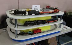 three tiered model train display with toy trains on it