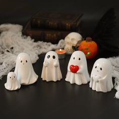 some white ghost figurines sitting on a table