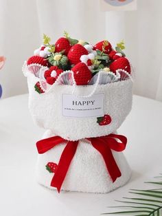 a white bag filled with strawberries on top of a table