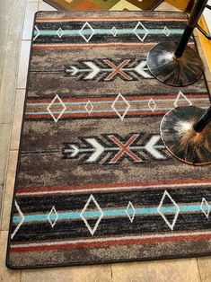 an area rug on the floor with two chairs next to it