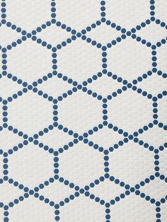 a white and blue tile with circles on the floor in different sizes, shapes and colors