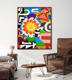 an abstract painting hangs on the wall above a chair and ottoman in a living room