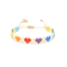 a white bracelet with colorful crosses on it