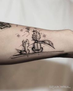 a person's arm with a tattoo on it that has a boat in the water